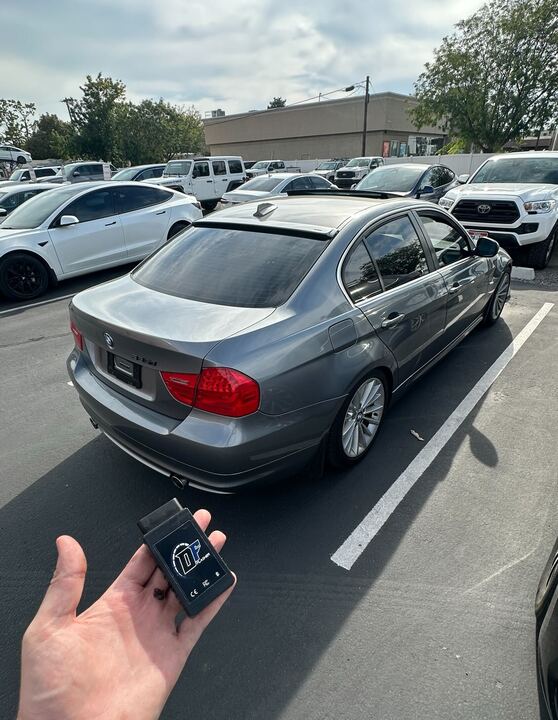BMW E90 335d owner with DFlasher OBD adapter in parking lot